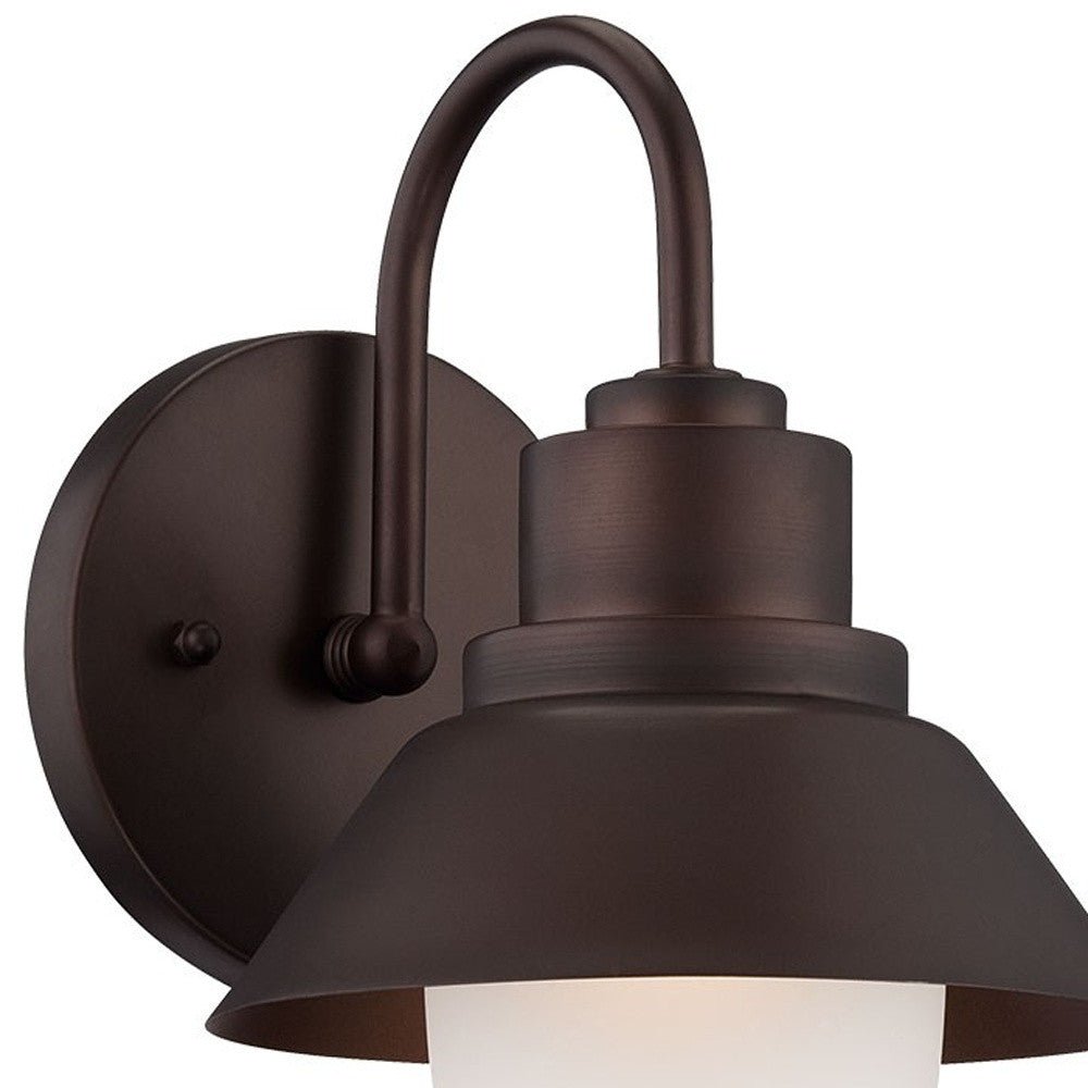 Zoomed in view of the wall plate, gooseneck arm and shade of the Bronze outdoor wall light with lamp shade design and frosted glass globe – durable weather-resistant exterior wall lighting fixture.