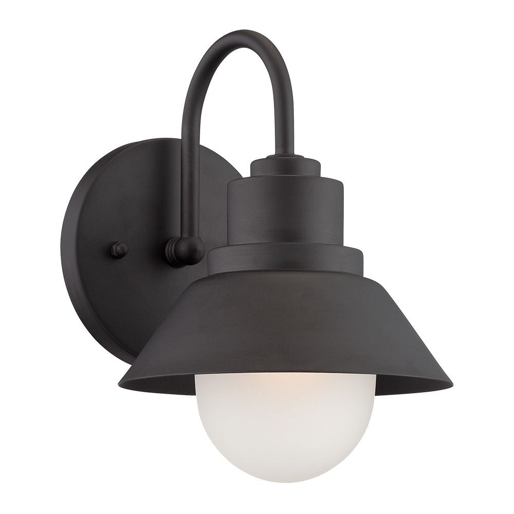 Left side angled view of the lighted Matte black outdoor wall light with lamp shade design and frosted glass globe – modern weather-resistant steel exterior wall lighting fixture.