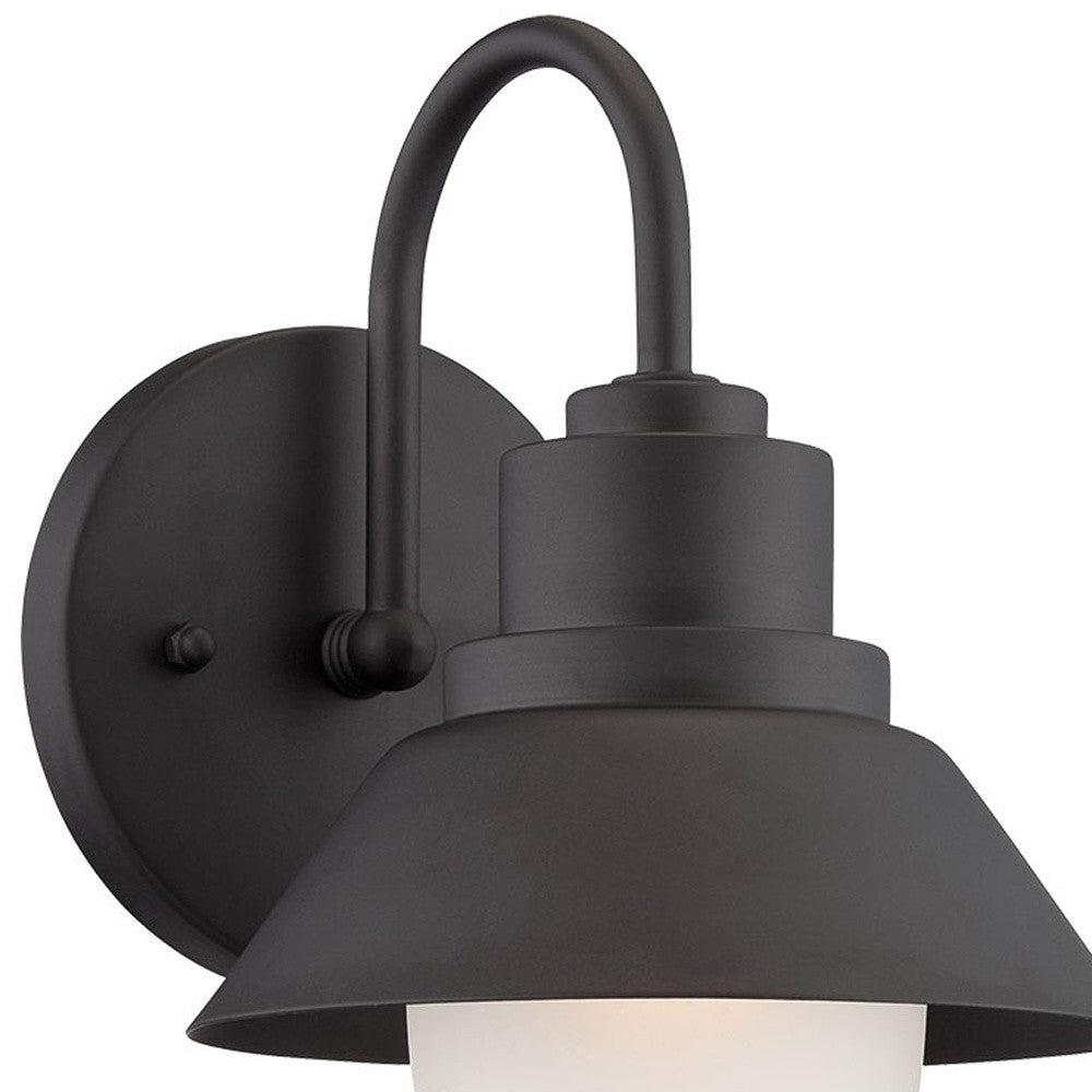 Left side zoomed in angled view of the lighted Matte black outdoor wall light with lamp shade design and frosted glass globe – modern weather-resistant steel exterior wall lighting fixture.