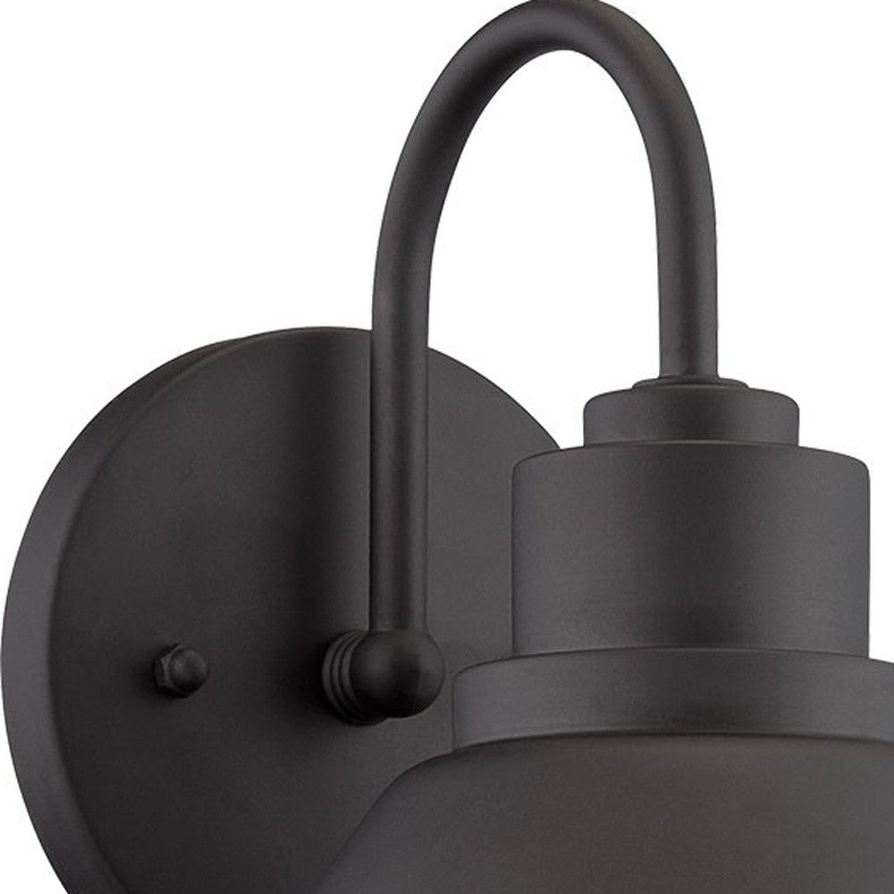 Zoomed in view of the wall plate and curved arm of the lighted Matte black outdoor wall light with lamp shade design and frosted glass globe – modern weather-resistant steel exterior wall lighting fixture.