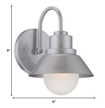 Brushed silver outdoor wall light with lamp shade design and frosted glass globe – modern weather-resistant steel exterior wall lighting fixture shown with dimensions of 9 inches high by 6 inches wide