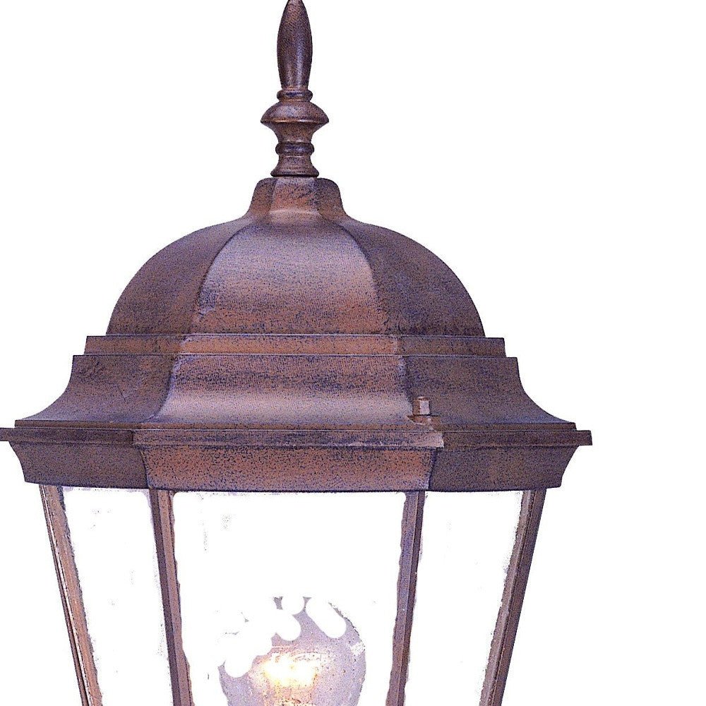 Zoomed in view of the lantern top of the lighted Dark brown swing arm outdoor lantern wall light with clear glass and dome top – classic exterior wall lighting for patios and entryways.