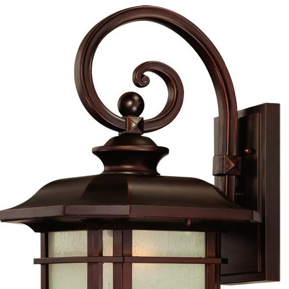 Zoomed in view of the wall plate and scroll arm of the lighted Somerset bronze outdoor wall light with frosted glass – Craftsman lantern design for porch, patio, or entryway.