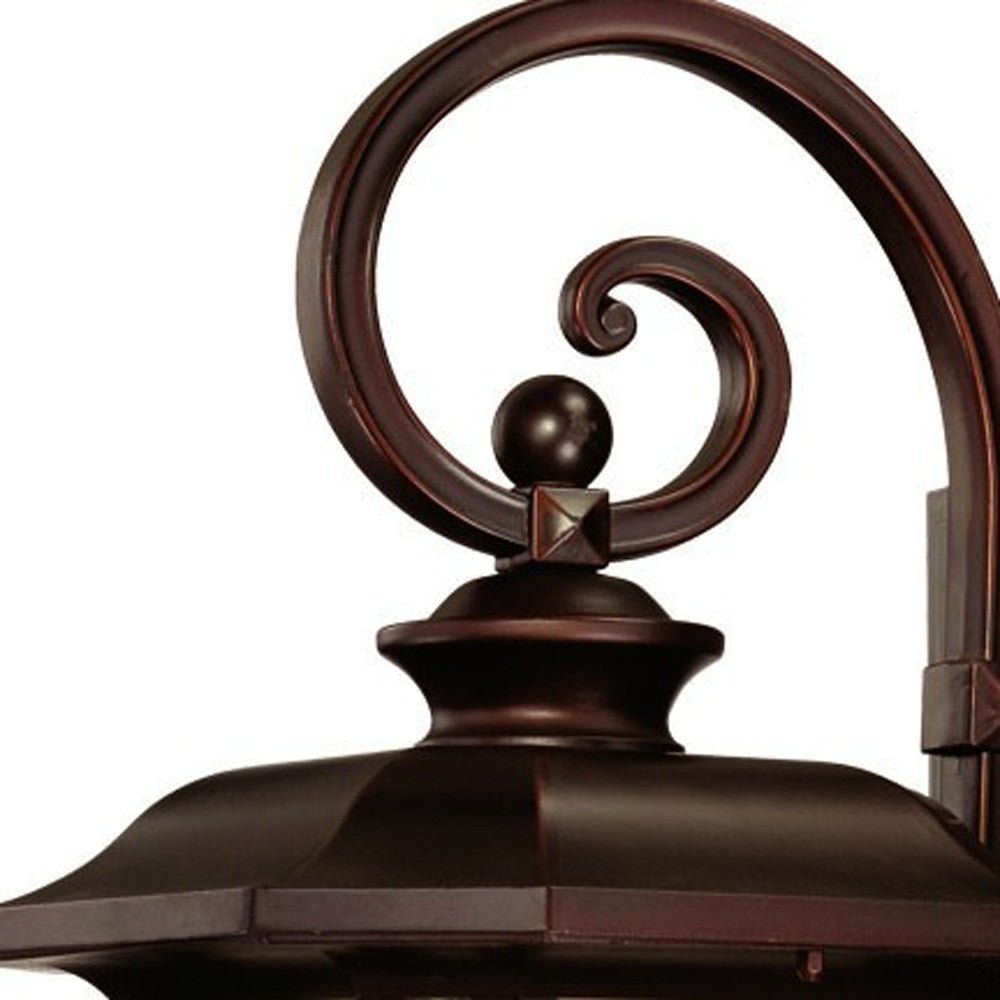 Zoomed in view of the scroll arm and lantern top of the Somerset bronze outdoor wall light with frosted glass – Craftsman lantern design for porch, patio, or entryway.