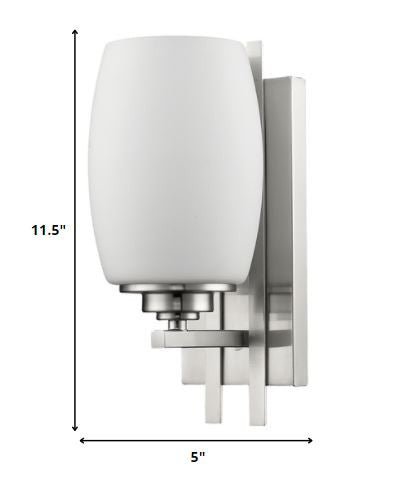 Geometric silver wall sconce with frosted glass shade for modern indoor home lighting shown with dimensions of 11 point 5 inches high by five inches wide