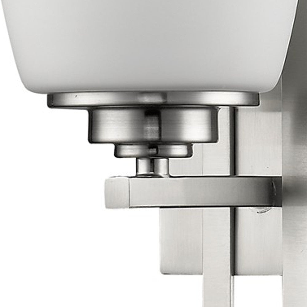 Zoomed in view of the wall plate, arm and base of the Geometric silver wall sconce with frosted glass shade for modern indoor home lighting