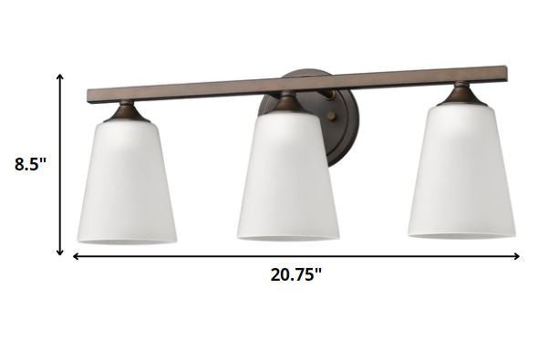 Three Light Bronze Metal Vanity Wall Light with frosted glass shades and bronze finish, modern bathroom lighting fixture shown with dimensions of 20.75 inches wide by 8.5 inches high