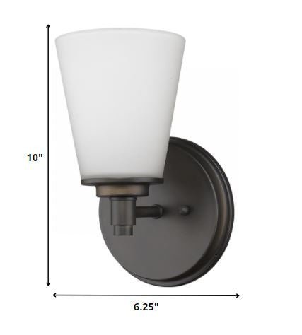 Single bronze wall light with tapered frosted glass shade and round backplate shown with dimensions of ten inches high by six point two five inches wide