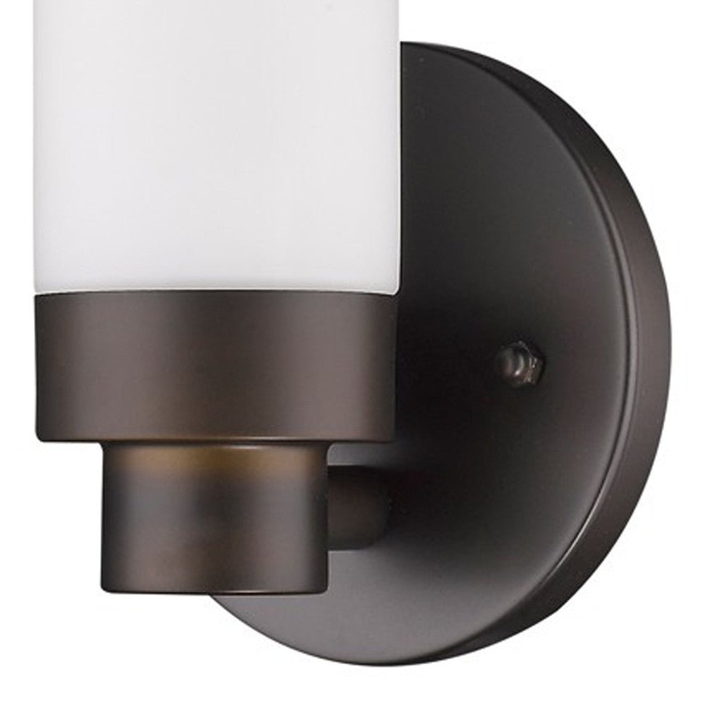 Zoomed in view of the wall plate, arm and cylinder of the Bronze Wall Sconce with Narrow Frosted Cylinder Glass Shade and minimalist design