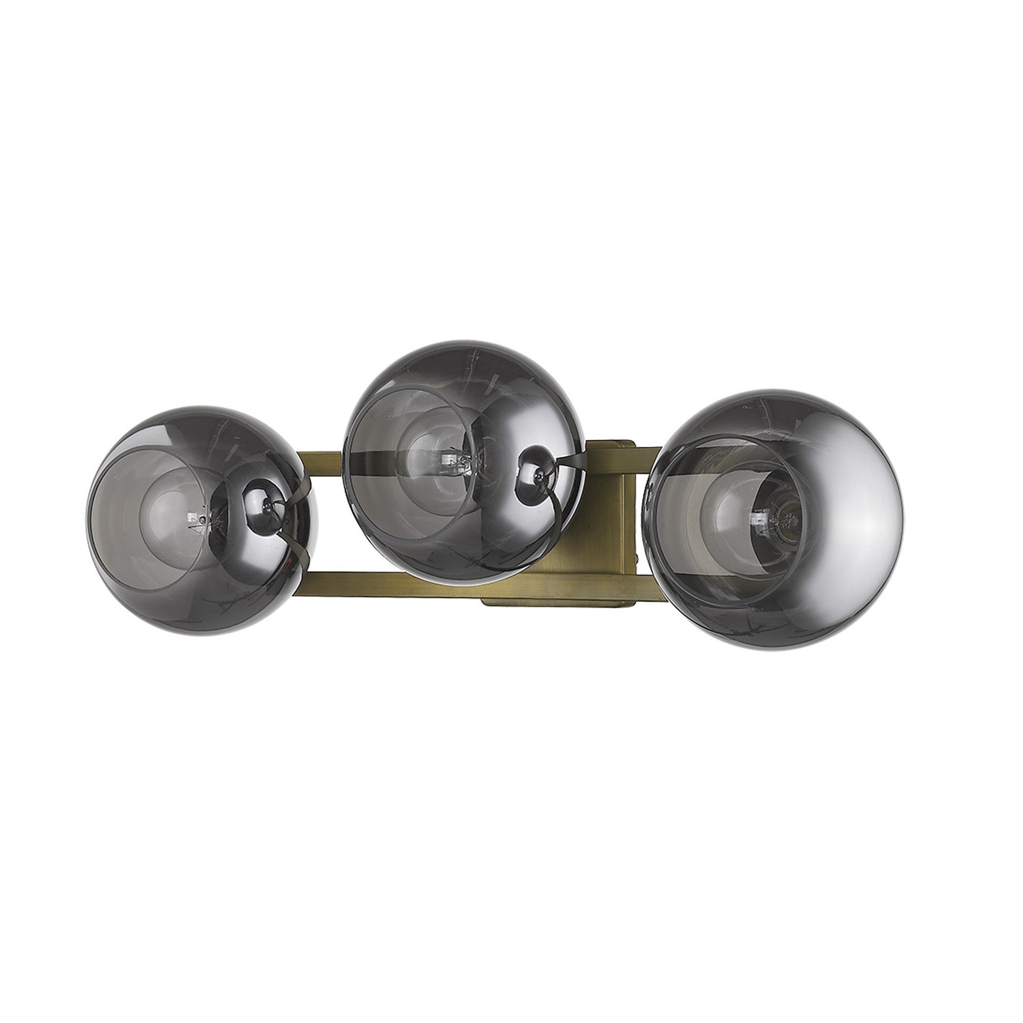 An angled view of an Aged brass sconce with three smoked handblown glass shades, emitting a warm light, from the Lunette collection.
