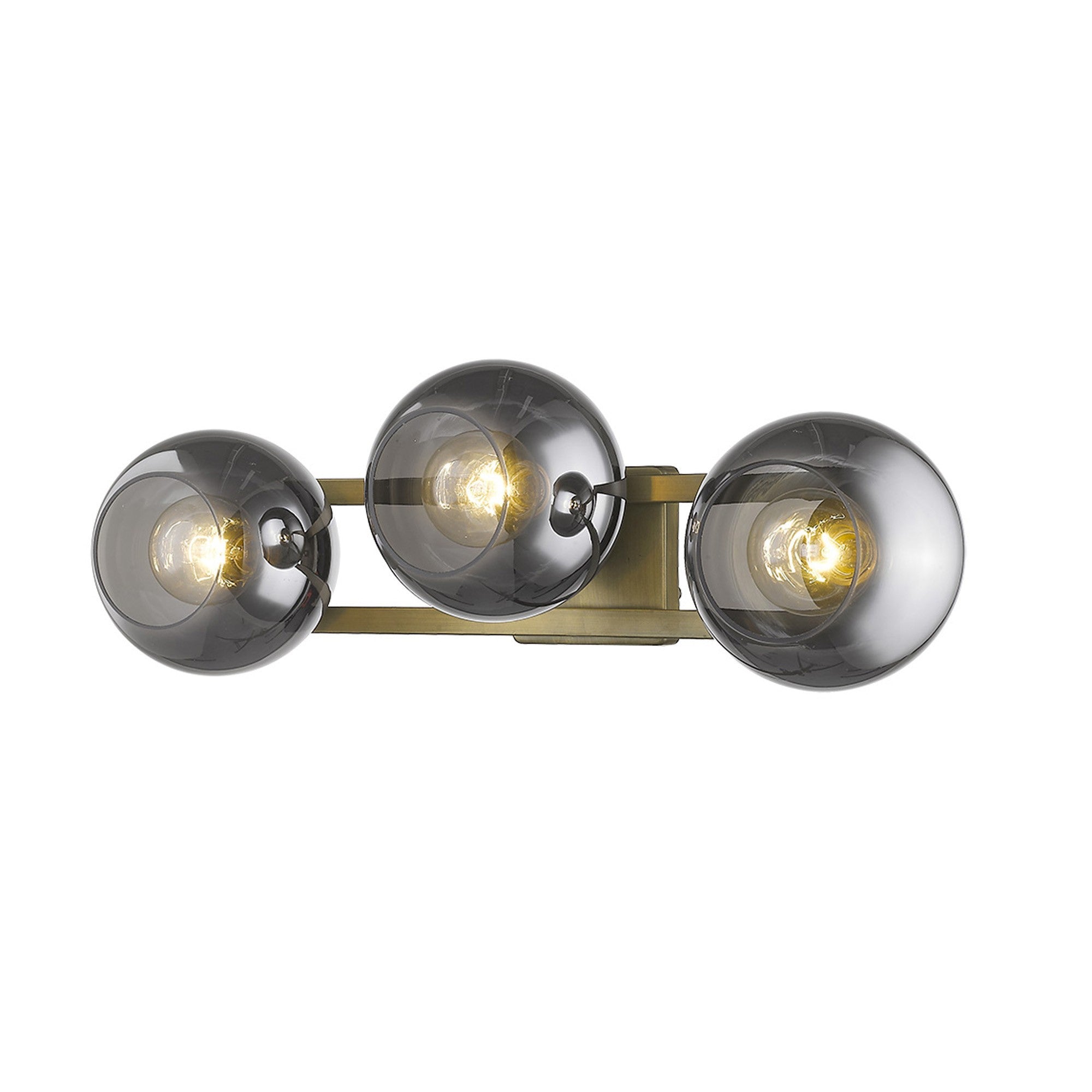 An angled view of a lighted Aged brass sconce with three smoked handblown glass shades, emitting a warm light, from the Lunette collection.