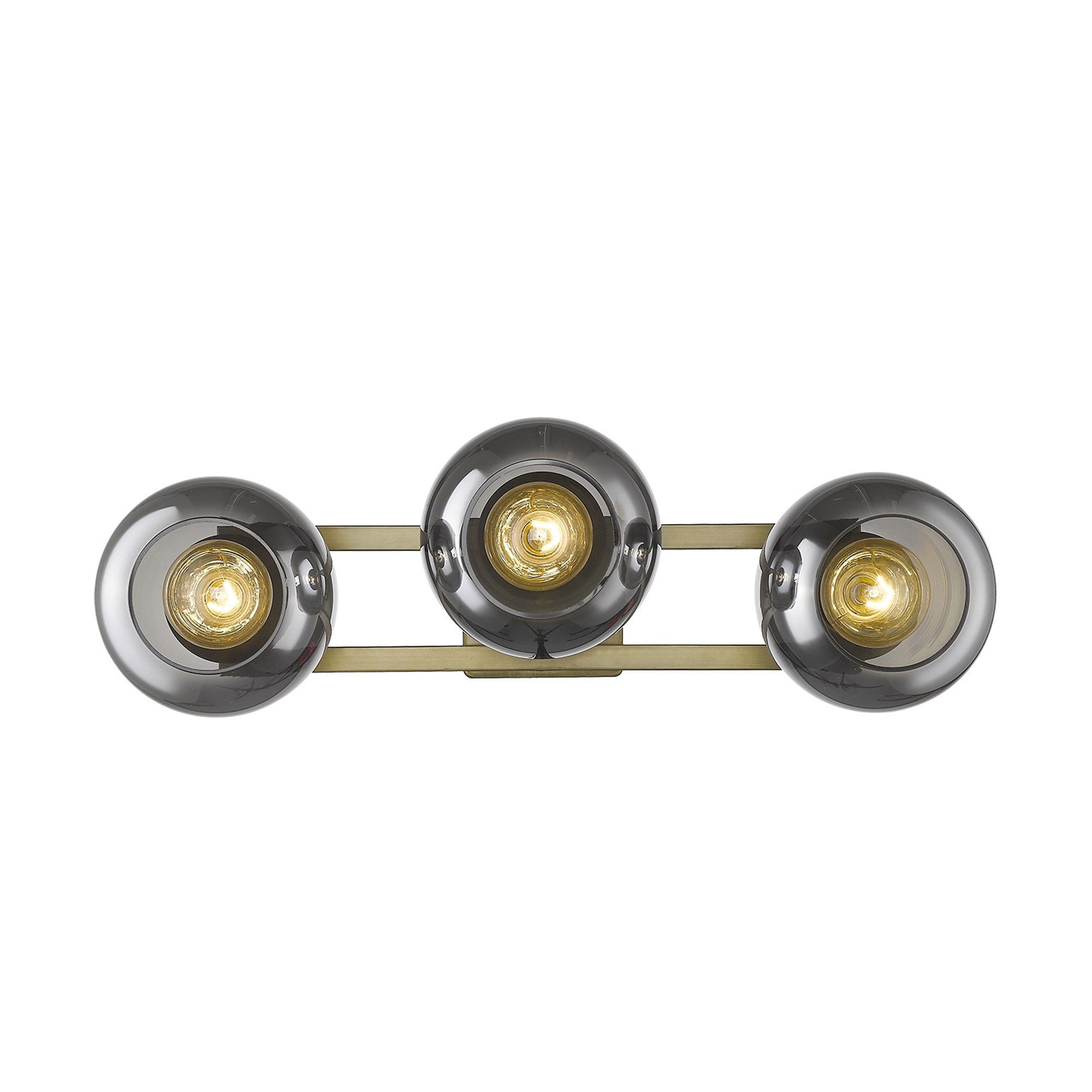An straight on view of a lighted Aged brass sconce with three smoked handblown glass shades, emitting a warm light, from the Lunette collection.