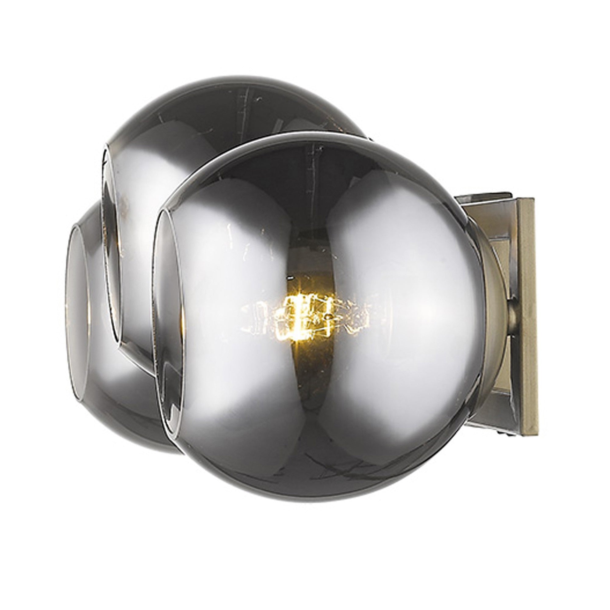 An side view of a lighted Aged brass sconce with three smoked handblown glass shades, emitting a warm light, from the Lunette collection.