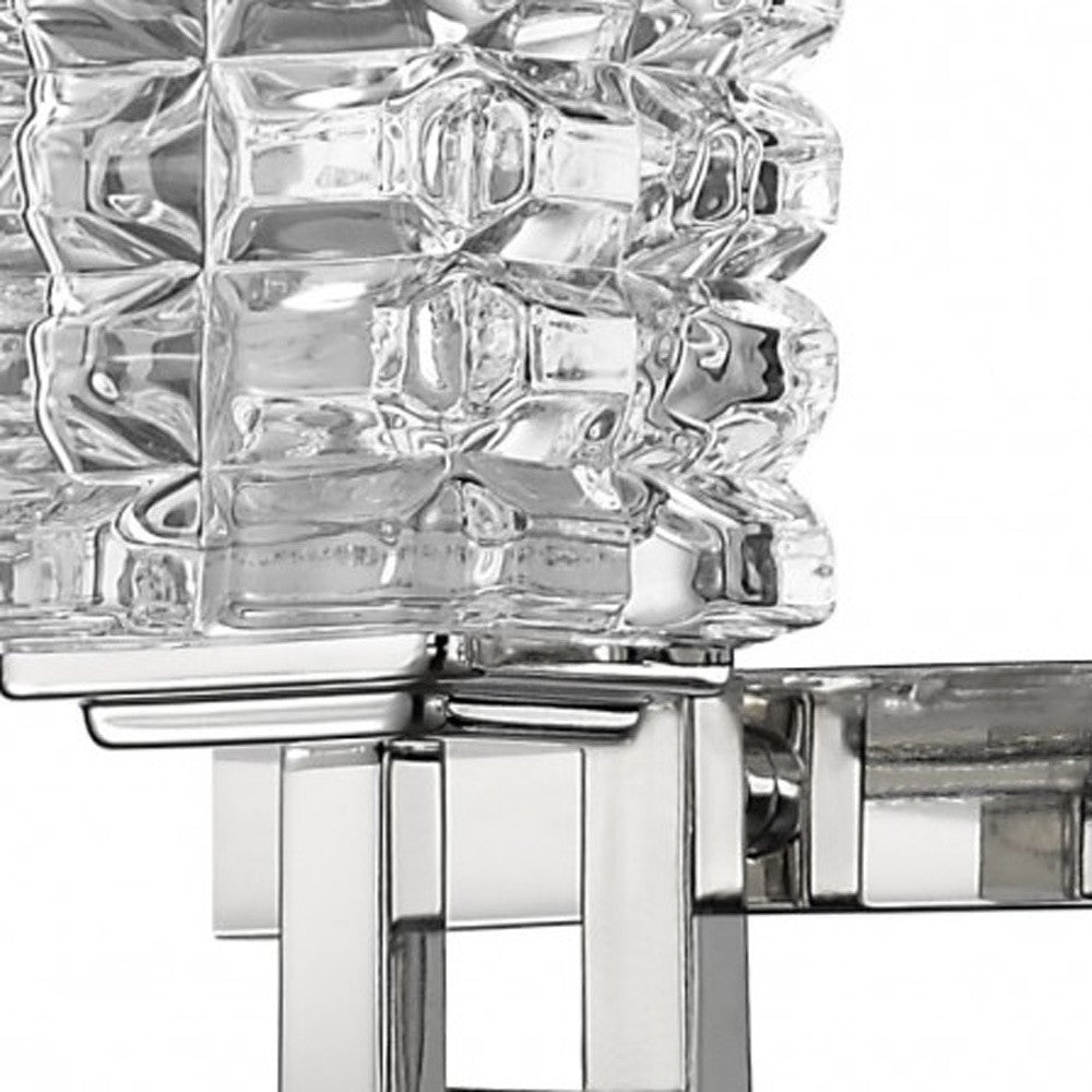 Close up view of one of the arms on the Coralie Three-light chrome vanity wall fixture with geometric crystal glass shades