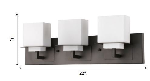 Oil-rubbed bronze three-light vanity fixture with modern square frosted glass shades shown with dimensions