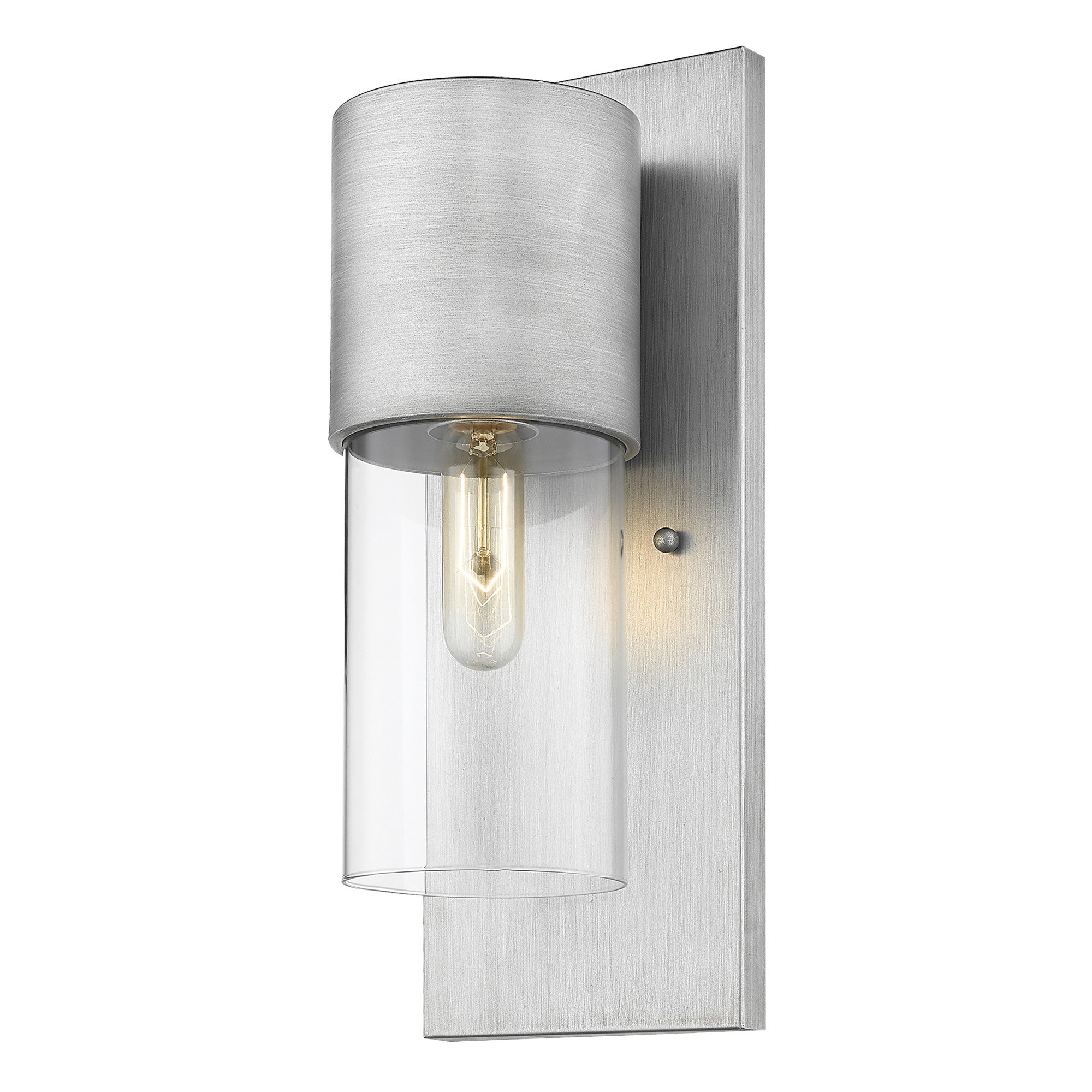 Angled view of a lighted Modern brushed nickel wall sconce with clear cylindrical glass shade and vertical backplate
