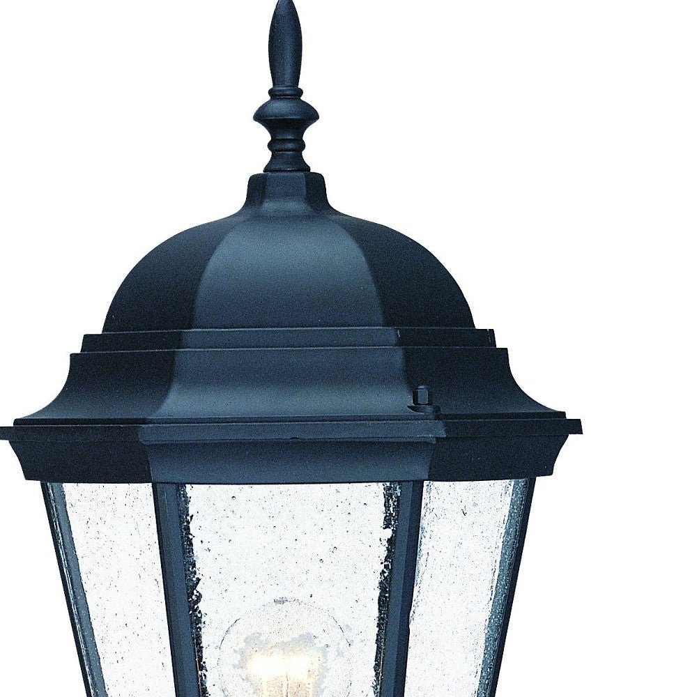 Close-up of seeded glass panels and finial on traditional black outdoor lantern