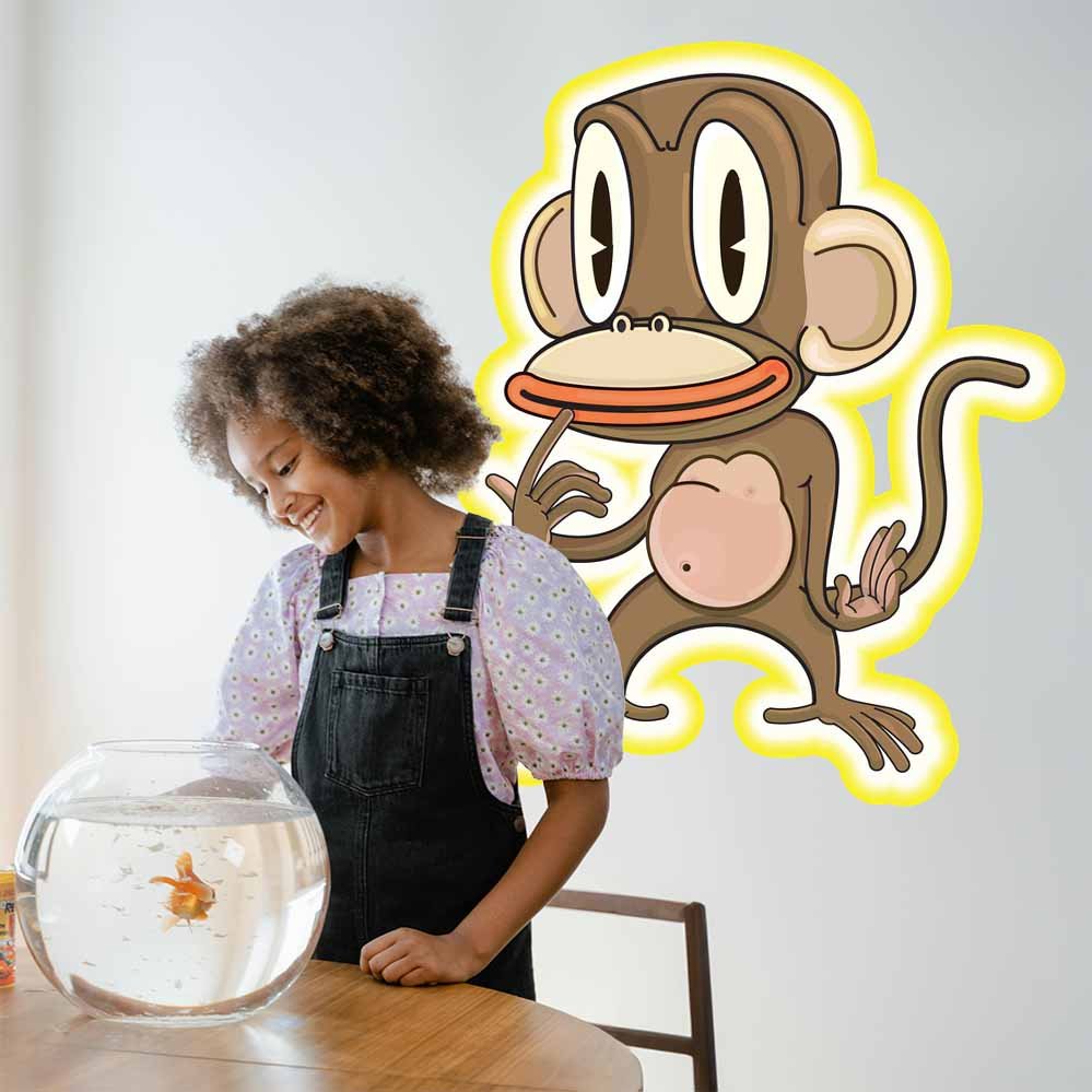 Child with a fishbowl and the 48 inch Pondering Monkey cartoon decal installed on a light gray wall.