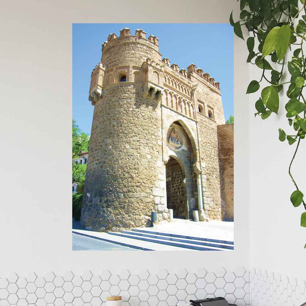 48 inch poster of Moors arch stone tower in Toledo Spain Displayed on a wall next to a hanging plant