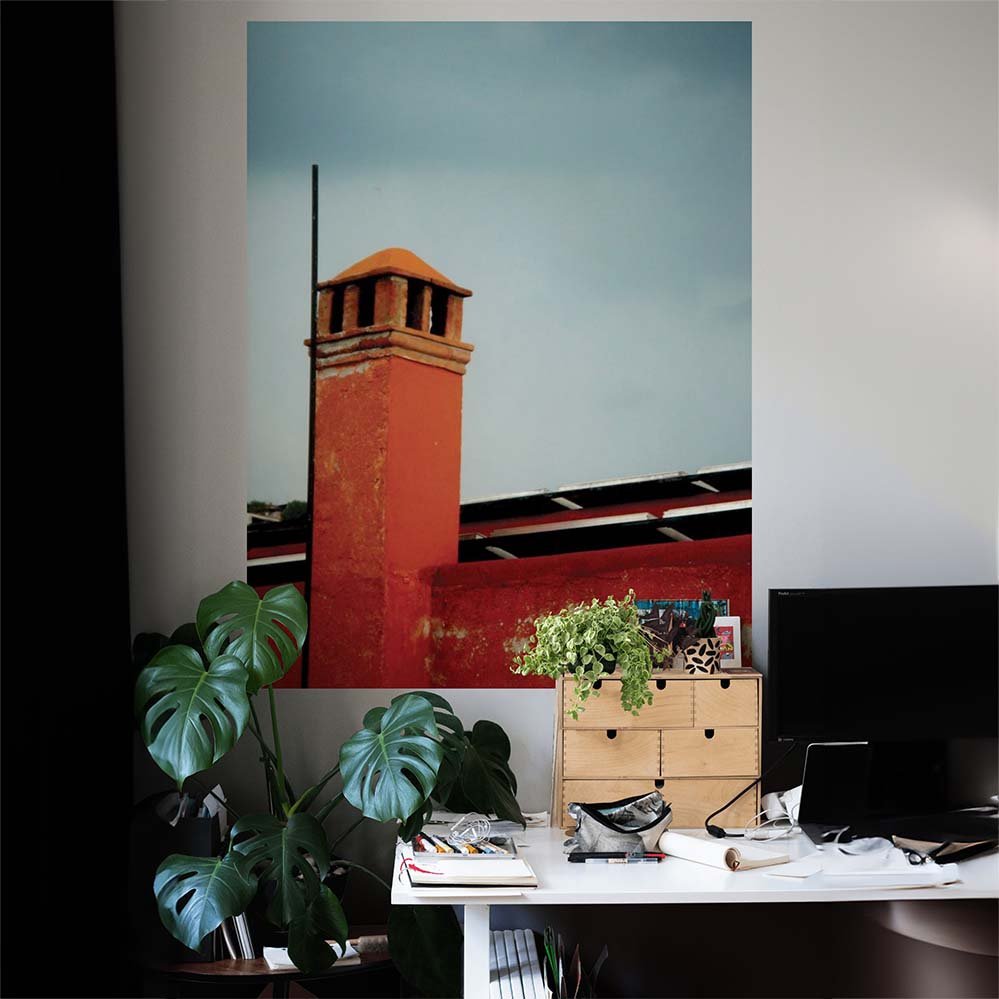 60 inch wall decal of a red brick Mexican chimney against a gray sky installed on wall above desk