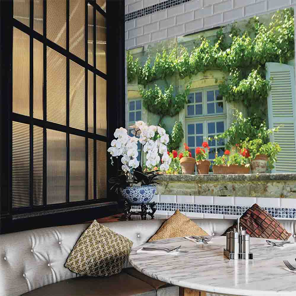 60 inch decal of a terrace in Auvillar France with ivy and flowerpots displayed on a wall in a restaurant