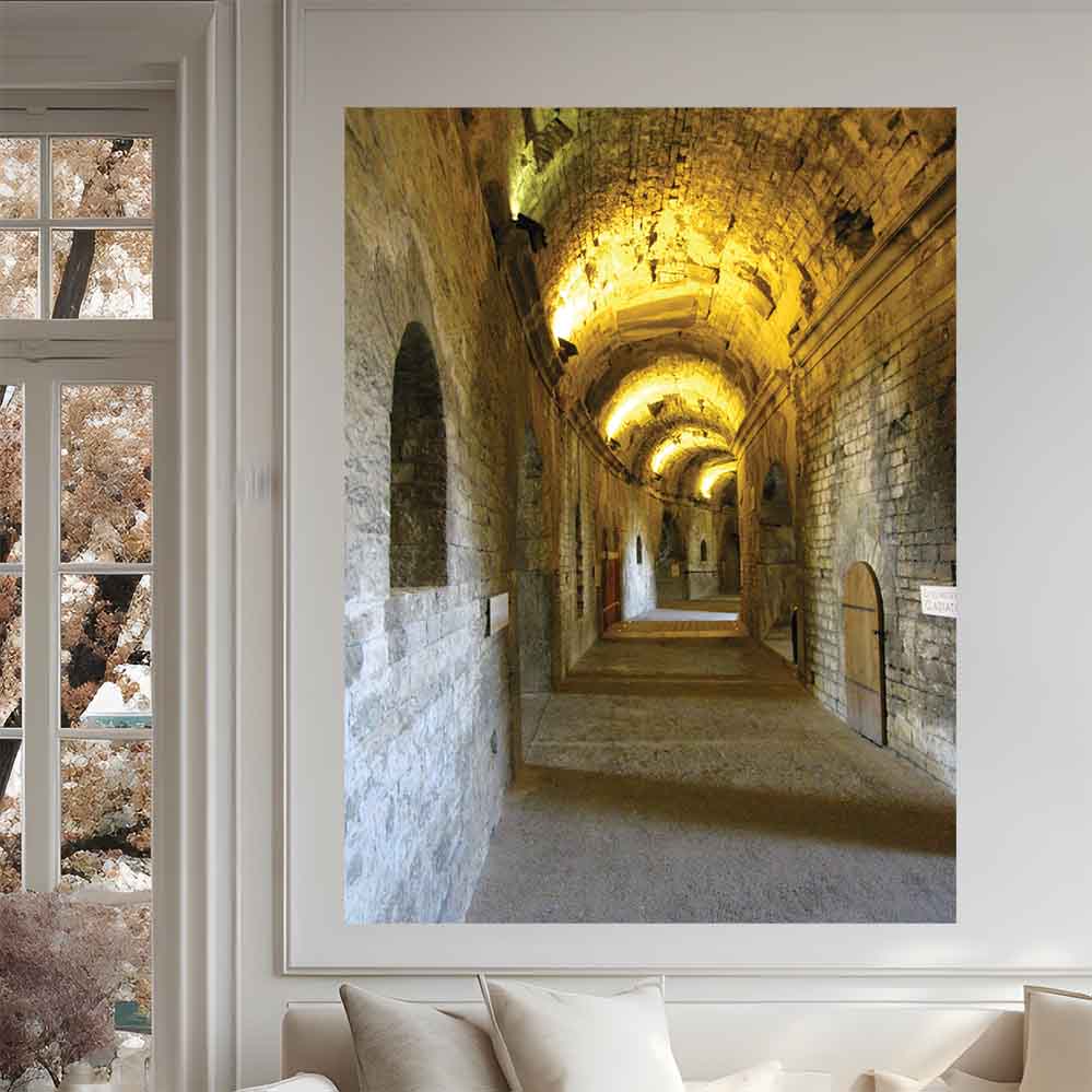 24 inch decal of a long, narrow hallway with arches in Nimes France Roman Arena installed on wall above sofa and next to window