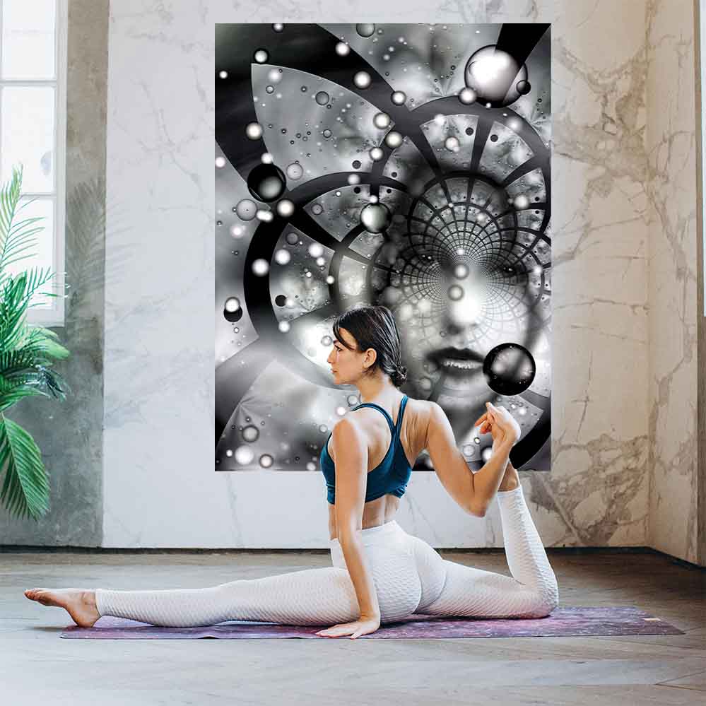 60 inch poster of an abstract black and white fractal artwork features the ghostly visage of a woman emerging from an abstract spiral of cosmic grids, celestial spheres, and radiant particles installed on wall with woman performing yoga in foreground