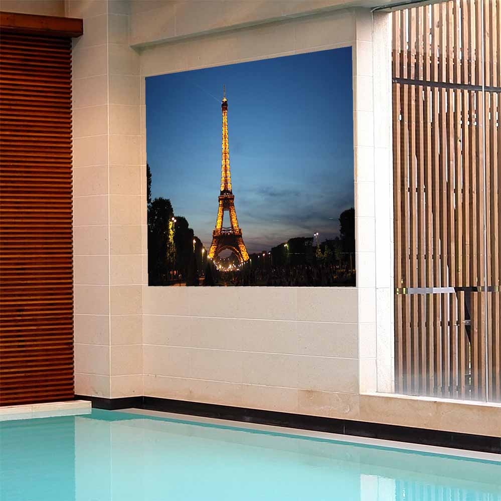 72 inch poster of the Eiffel Tower illuminated at dusk displayed on a wall in a pool area