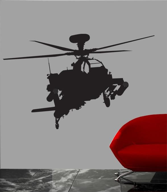 A black vinyl wall decal of an attack helicopter, shown applied to a gray wall in a room setting with a red chair and a marble floor visible.