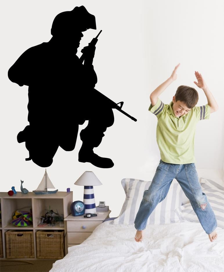 Military communications soldier kneeling with field radio and rifle silhouette wall decal by Jaycee Haynes installed in boys room