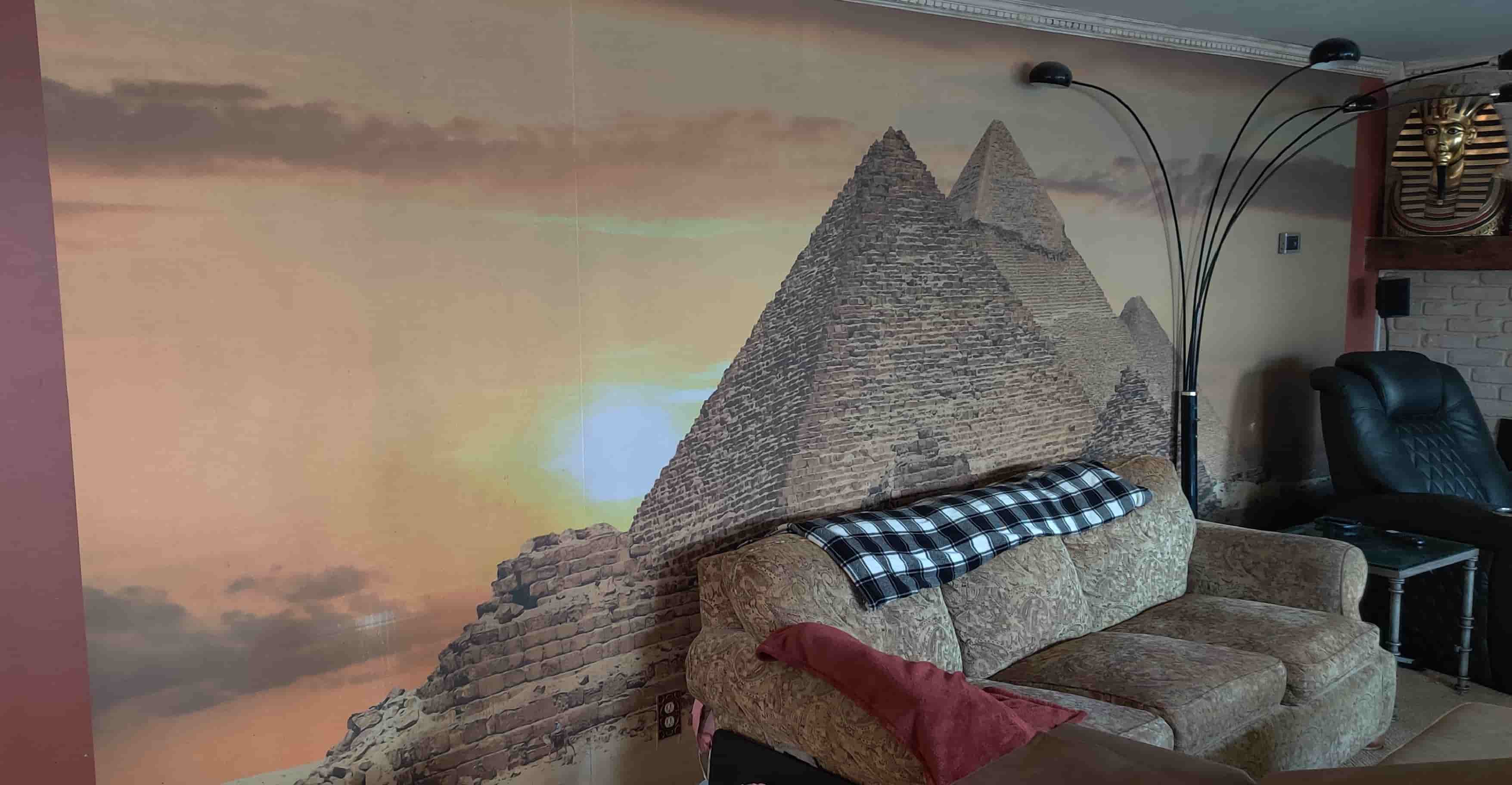 Massive wall mural of the Great Pyramids of Egypt installed in a Egyptian themed family room.