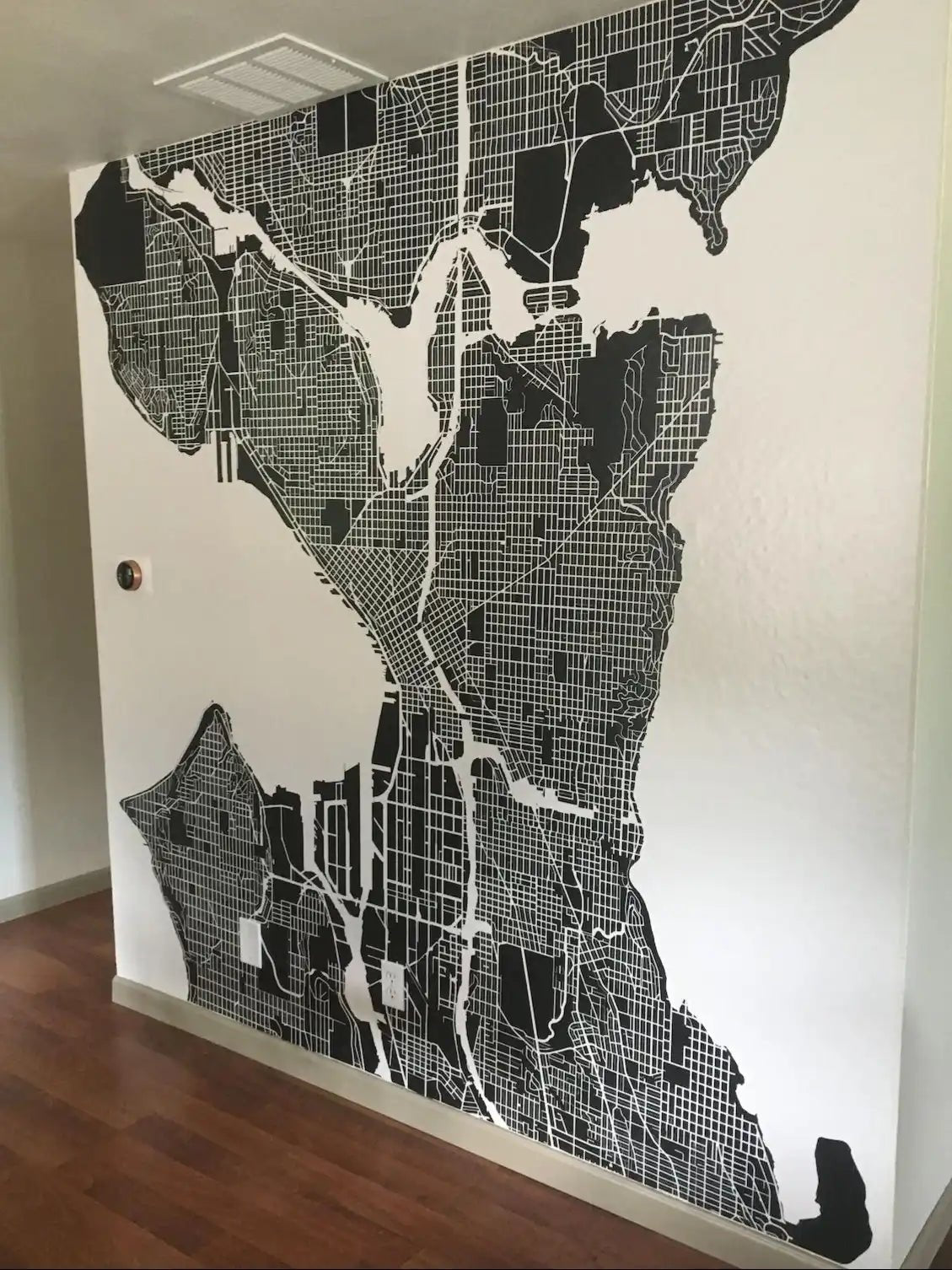 Metrepolitan black and white city map installed on wall.