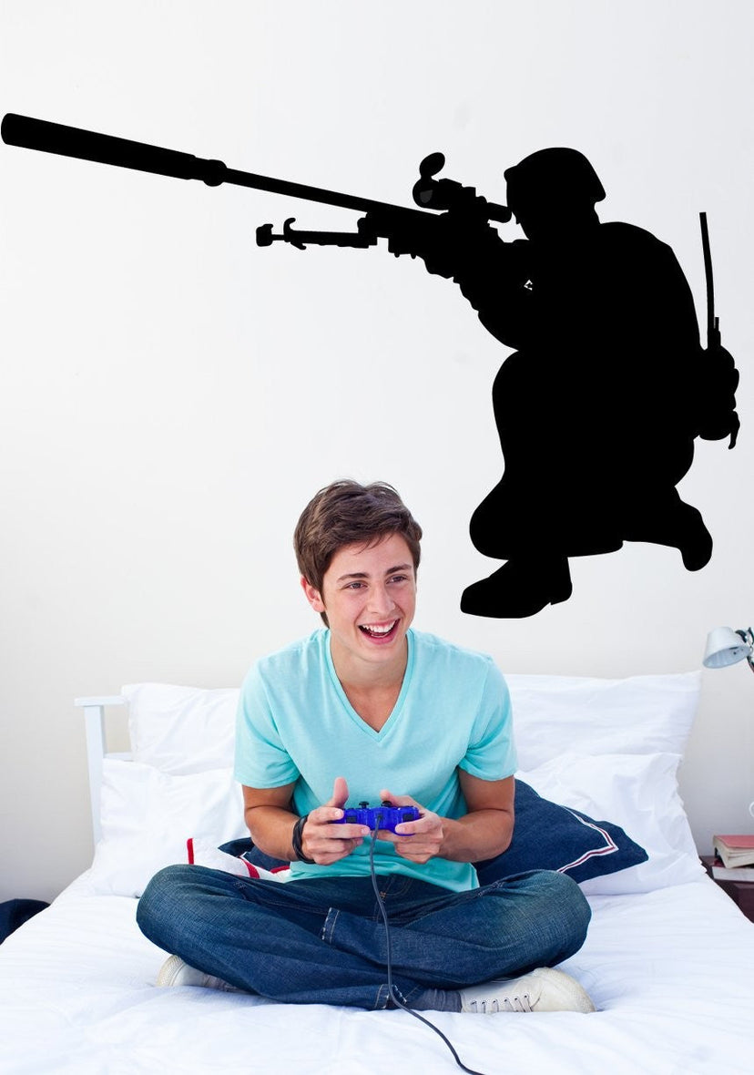 Military sniper kneeling with scoped rifle silhouette wall decal by Jaycee Haynes on wall in a teens bedroom