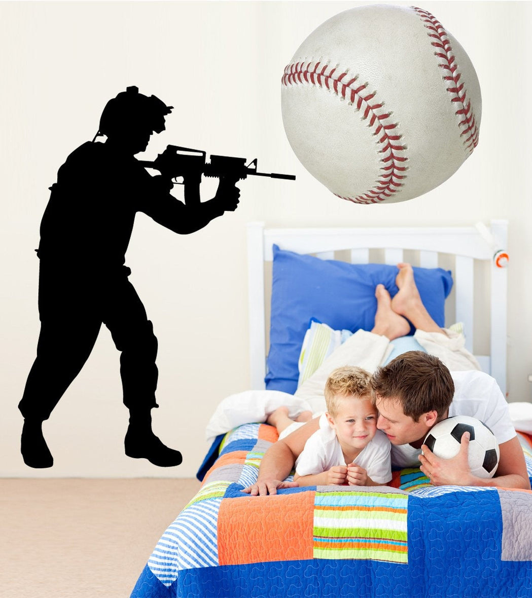Military soldier standing with rifle silhouette wall decal by Jaycee Haynes installed in boys bedroom
