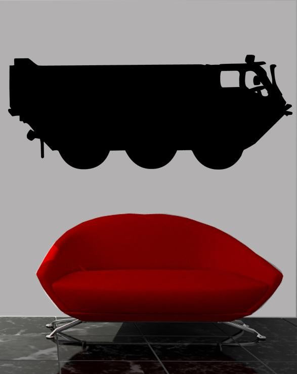 Military troop transport armored tactical vehicle silhouette wall decal by Jaycee Haynes installed on wall above red sofa